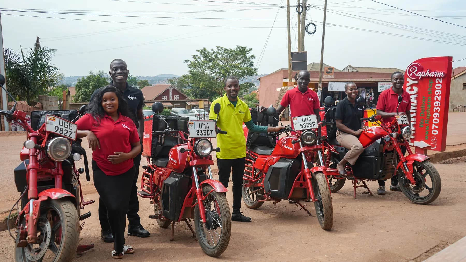 The Rapharm pharmacist and delivery rider team with their fleet in Kampala